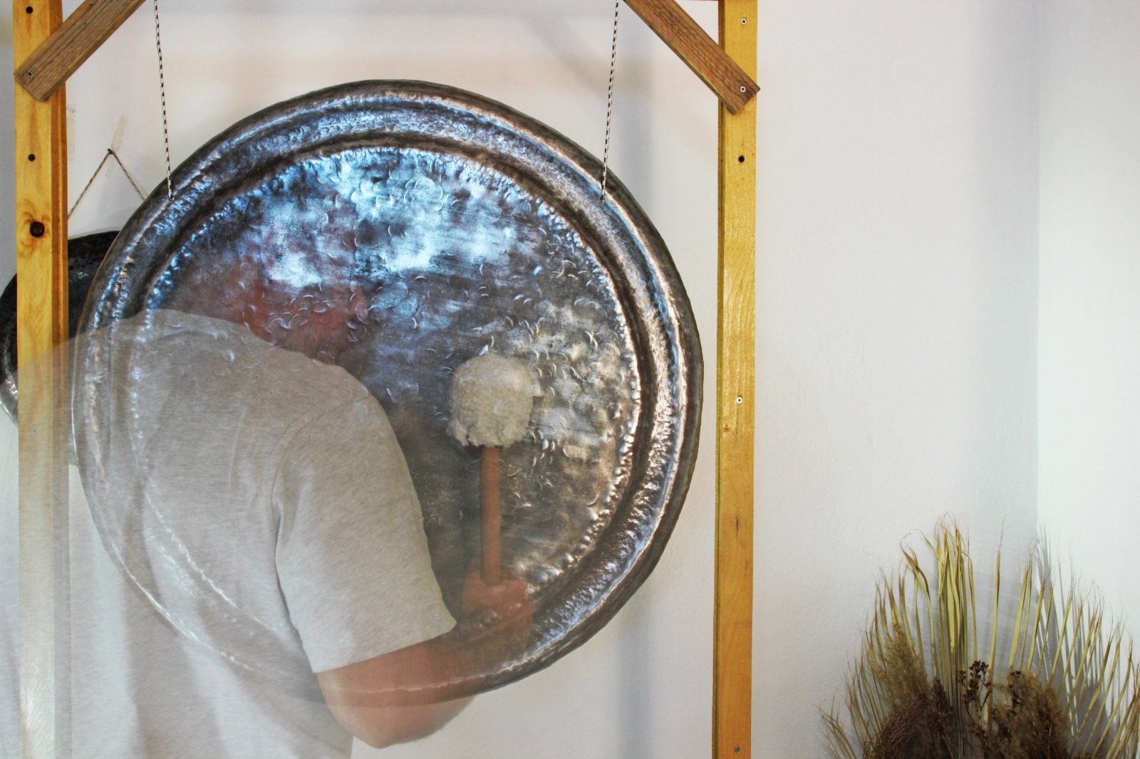 Tağmaç playing a hand-forged gong during a Sonic Journey session